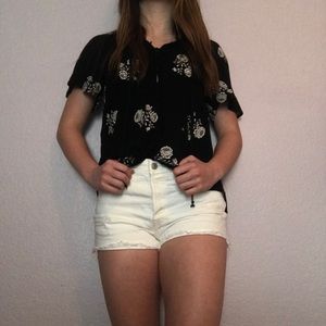 Black button up blouse with white flowers.